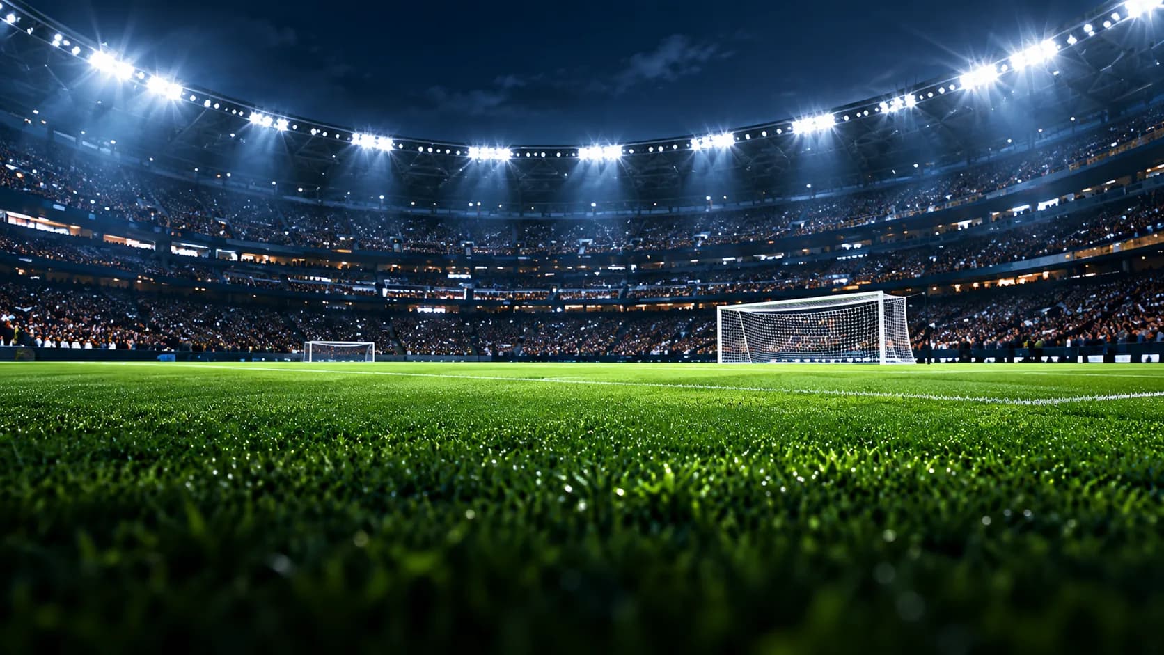A floodlit football stadium at night
